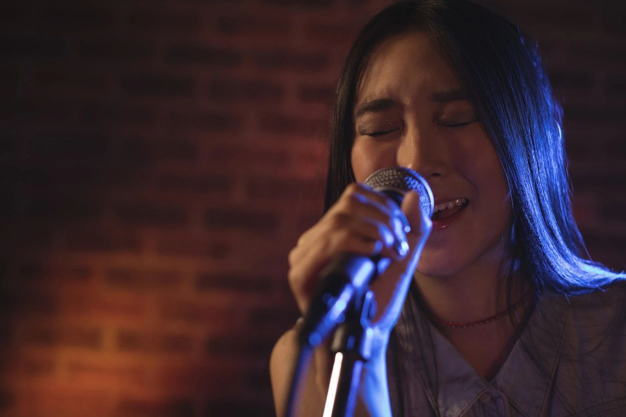 Female singer performing under blue stage light